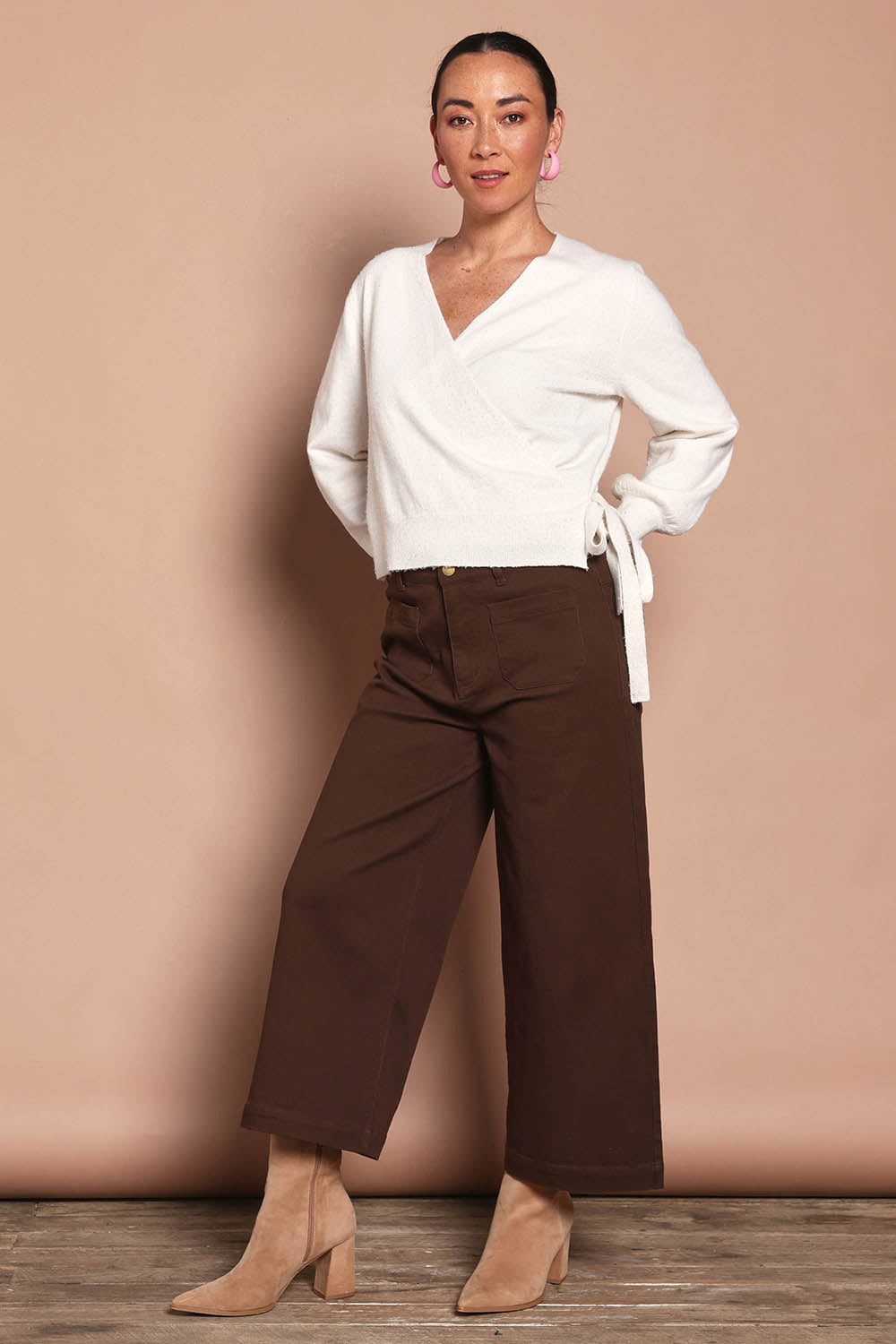 Model Katie wearing size S of the Wrap Knit Sweater in colour Cream (White), from the front, showing the whole outfit