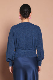 Model Katie wearing size S of the Wrap Knit Sweater in colour Dustyblue (Blue), from the back