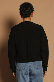 Model Katie wearing size S of the Cotton Cardigan in colour Black (Black), from the back