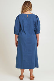 Model Chanel wearing size 16 of the Puff Sleeve Midi Cotton Dress in colour Moroccan (Blue), from the back