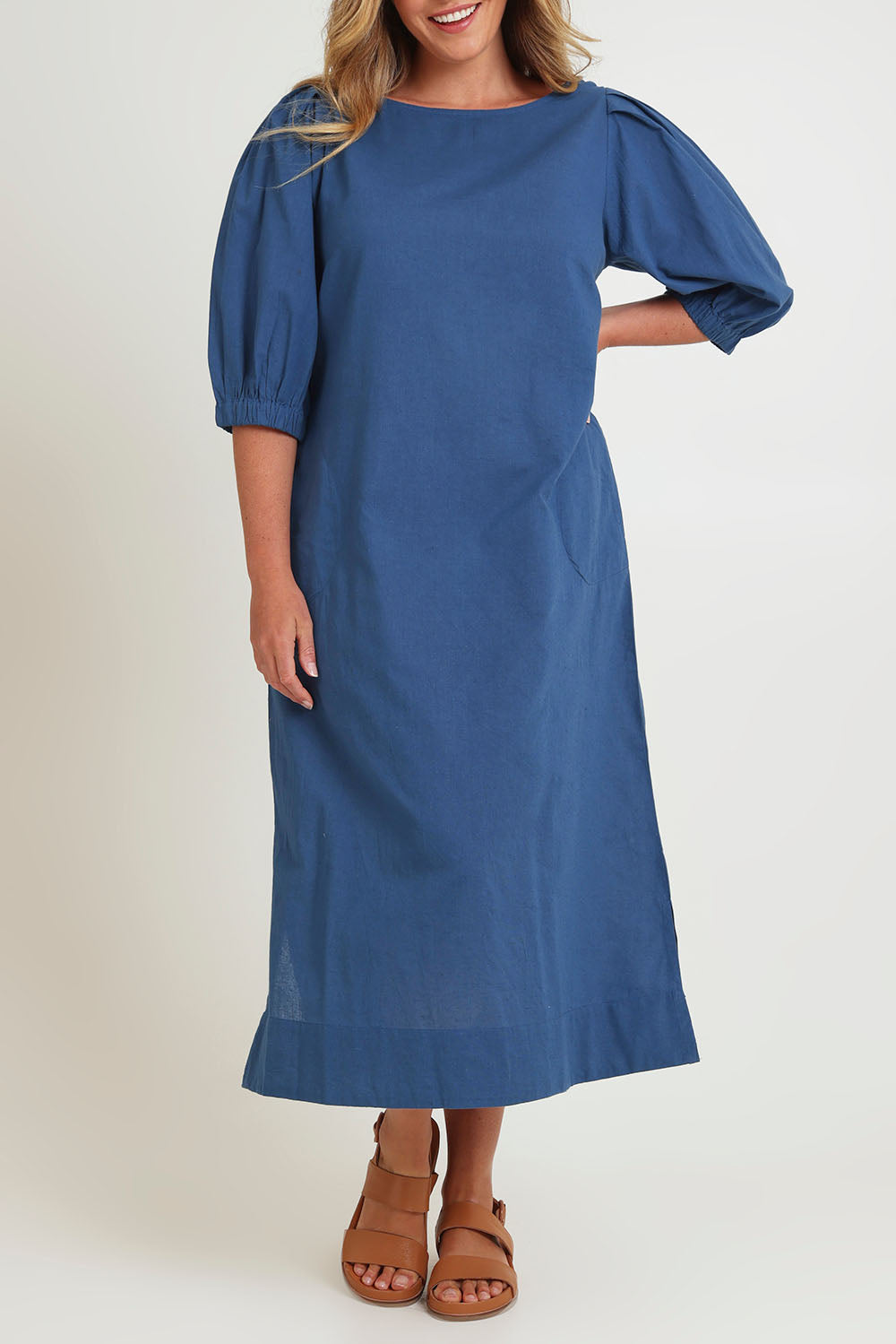 Model Chanel wearing size 16 of the Puff Sleeve Midi Cotton Dress in colour Moroccan (Blue), from the front, cropped image