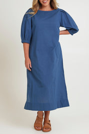 Model Chanel wearing size 16 of the Puff Sleeve Midi Cotton Dress in colour Moroccan (Blue), from the front, cropped image