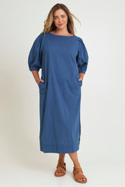 Model Chanel wearing size 16 of the Puff Sleeve Midi Cotton Dress in colour Moroccan (Blue), from the front, showing the whole outfit