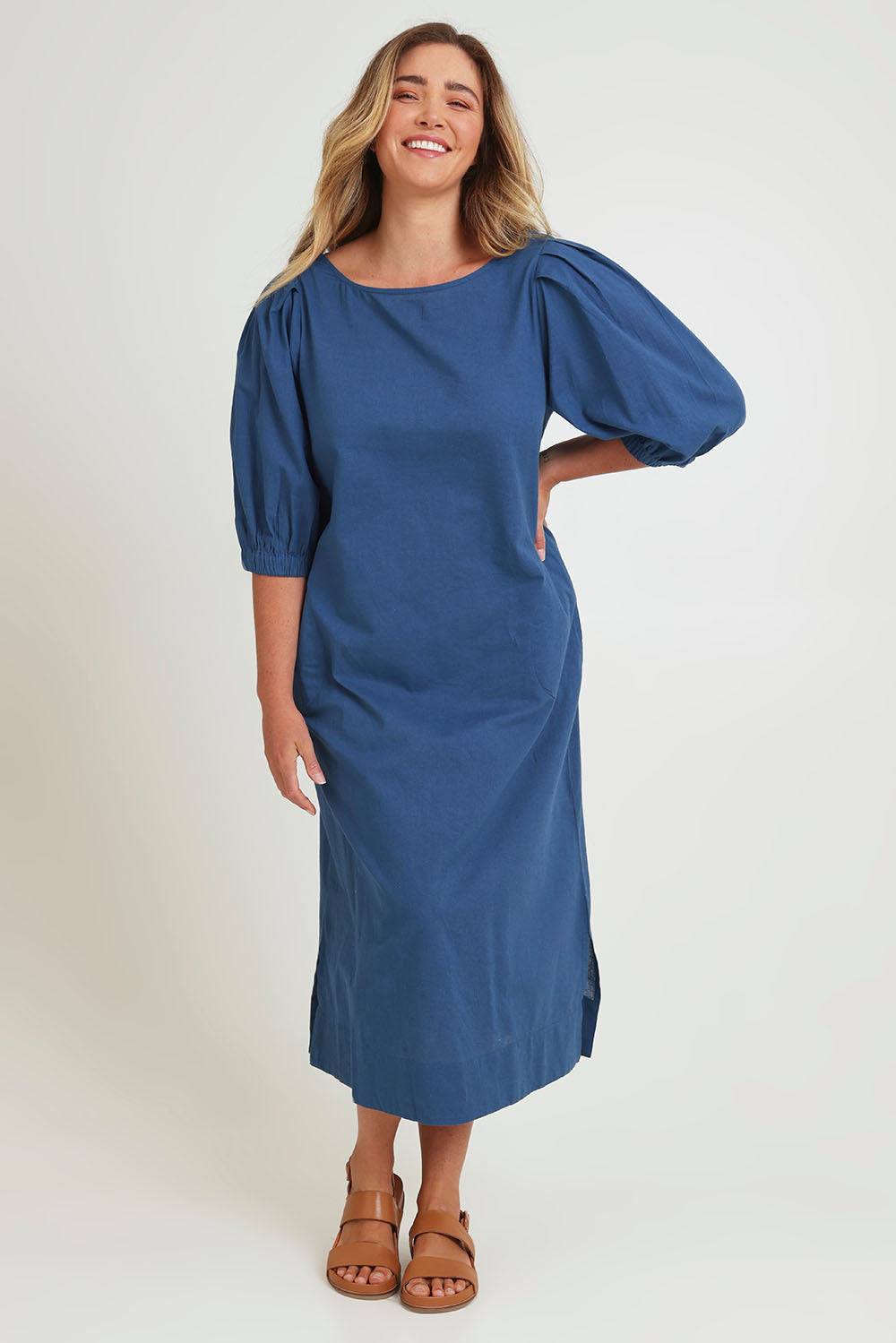 Model Chanel wearing size 16 of the Puff Sleeve Midi Cotton Dress in colour Moroccan (Blue), from the front, showing the whole outfit