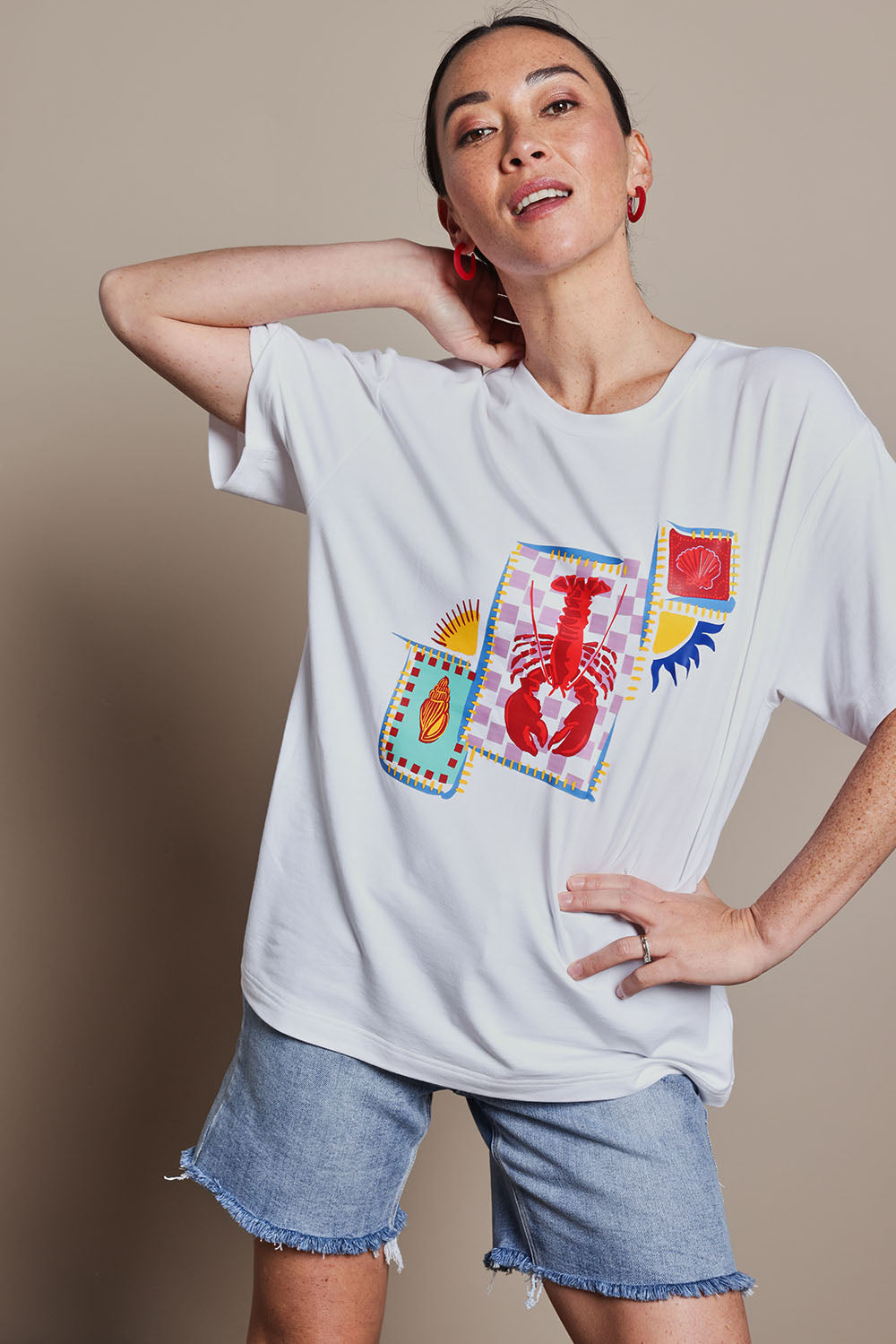 Model Katie wearing size 10 of the Printed Cotton Blend Tee in colour Lobster, from the front, cropped image