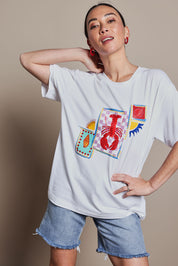 Model Katie wearing size 10 of the Printed Cotton Blend Tee in colour Lobster, from the front, cropped image