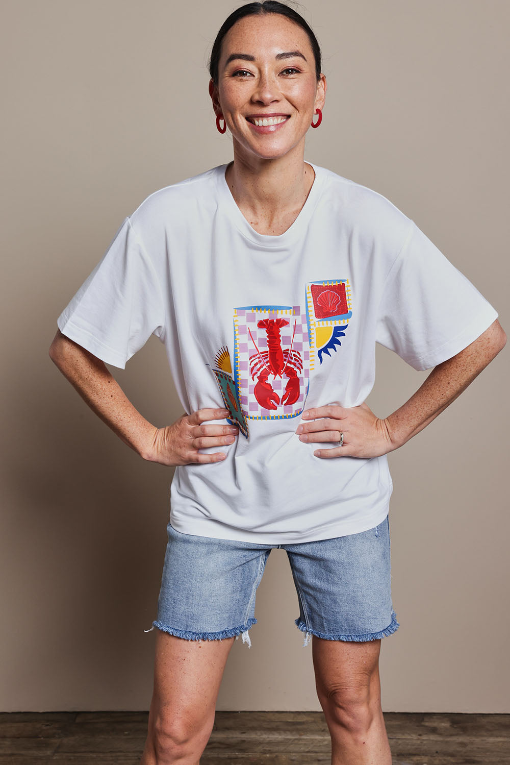 Model Katie wearing size 10 of the Printed Cotton Blend Tee in colour Lobster, from the front, cropped image