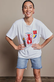 Model Katie wearing size 10 of the Printed Cotton Blend Tee in colour Lobster, from the front, cropped image