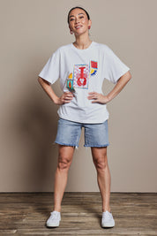 Model Katie wearing size 10 of the Printed Cotton Blend Tee in colour Lobster, from the front, showing the whole outfit