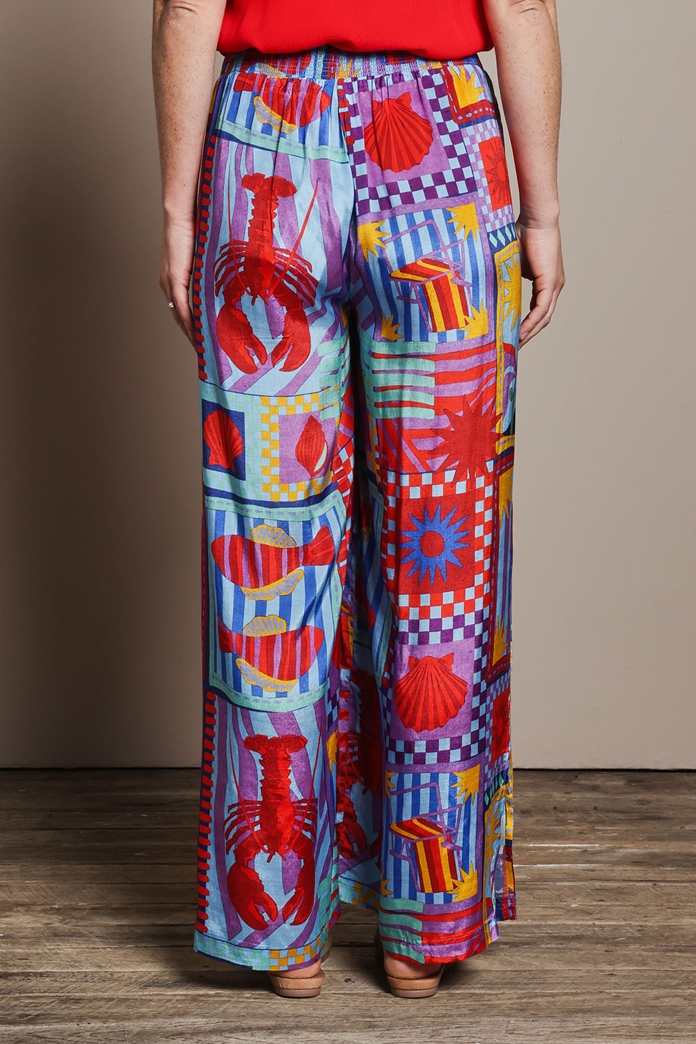 Model Katie wearing size 10 of the Straight Leg Pull On Pants in colour Lobster, from the back