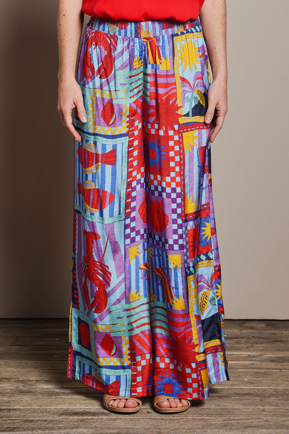 Model Katie wearing size 10 of the Straight Leg Pull On Pants in colour Lobster, from the front, cropped image