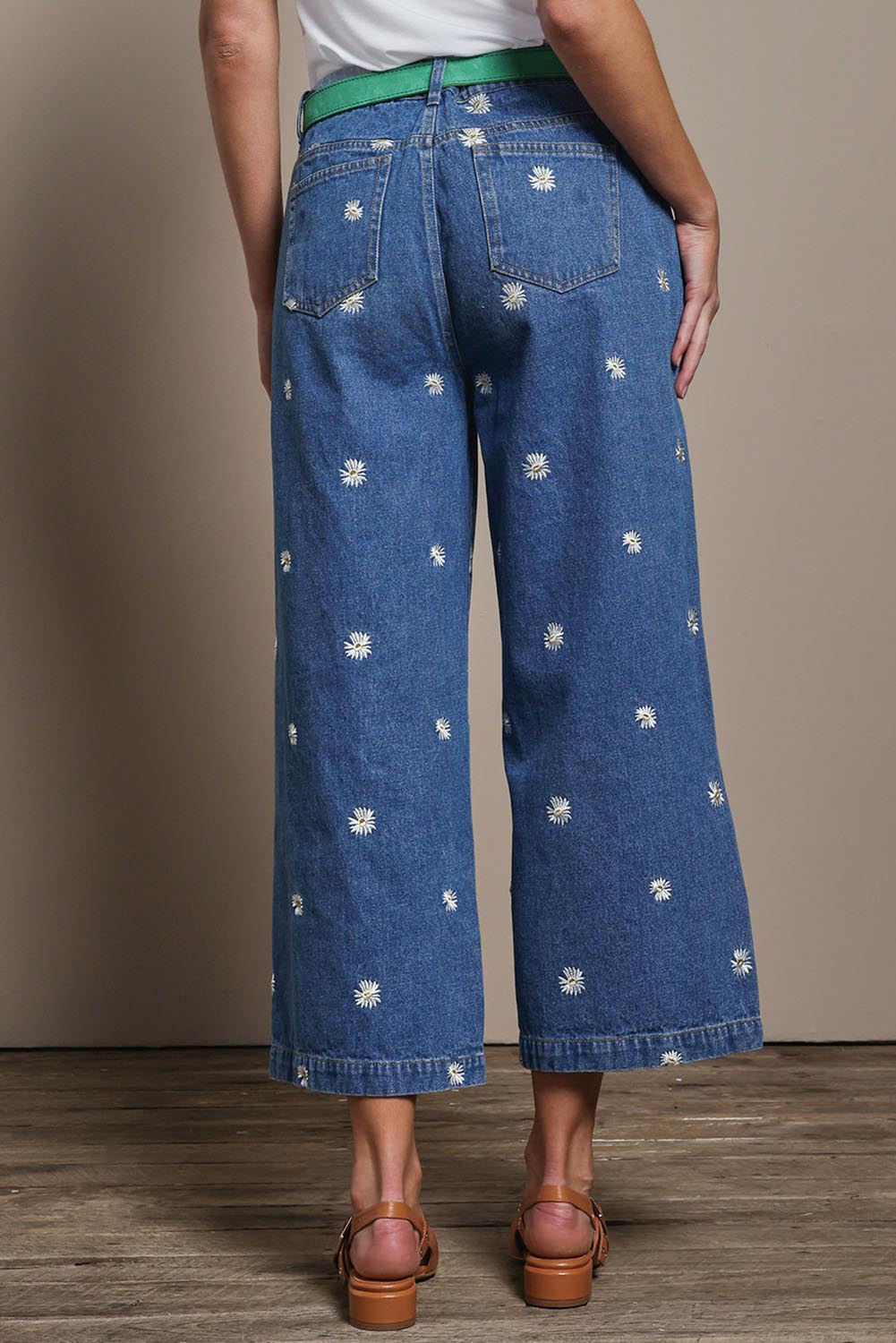 Model Madeline wearing size 10 of the Daisy Cotton Crop Jean in colour Daisy (Blue), from the back