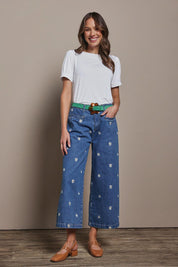 Model Madeline wearing size 10 of the Daisy Cotton Crop Jean in colour Daisy (Blue), from the front, showing the whole outfit