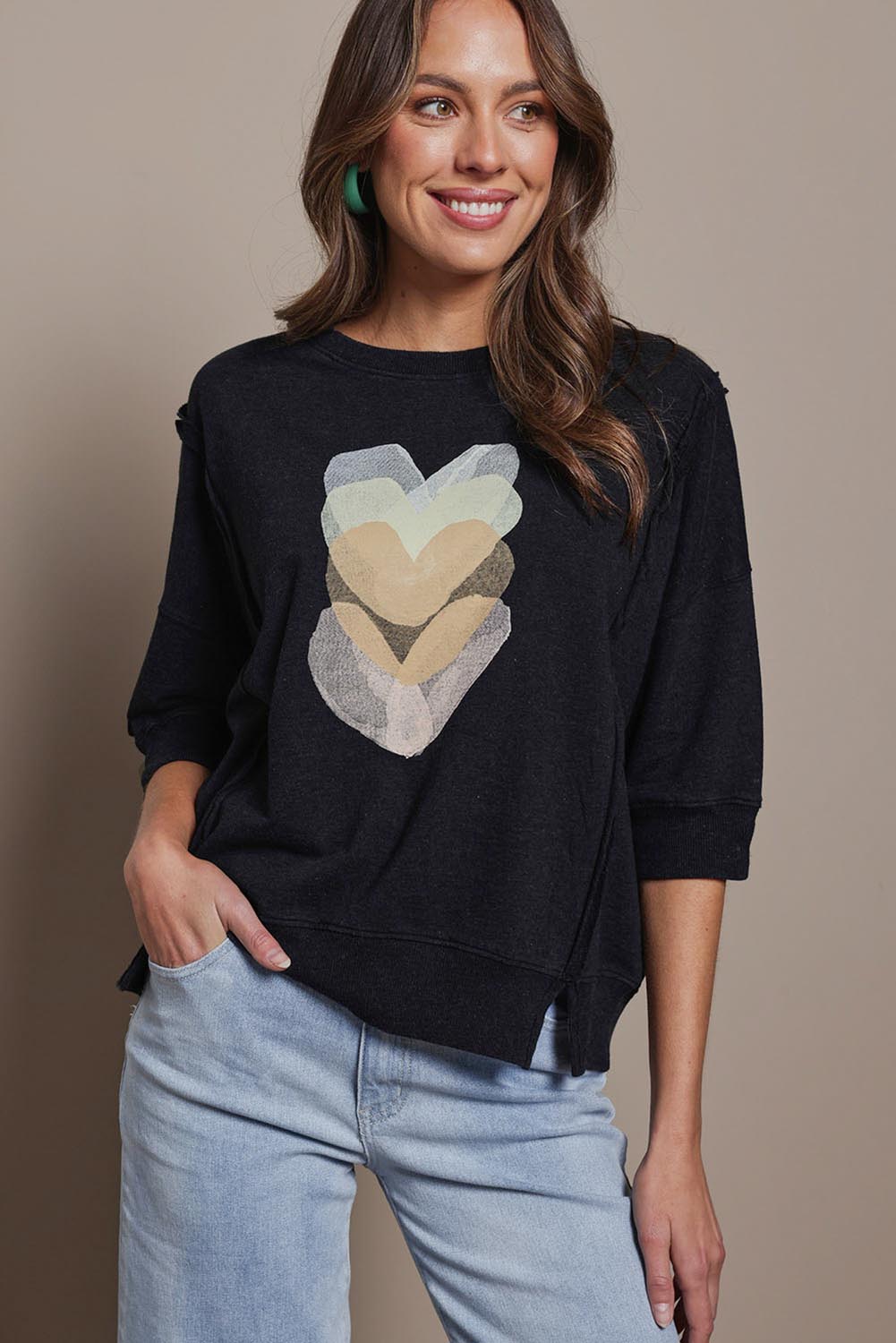 Model Madeline wearing size 10 of the Heart 3/4 Sleeve Cotton Jumper in colour Blackbeige (Black), from the front, cropped image