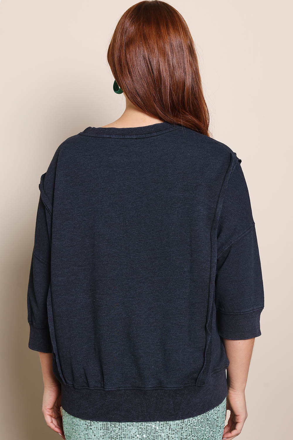 Model Georgiel wearing size 10 of the Heart 3/4 Sleeve Jumper – Blackblue in colour Blackblue, from the back