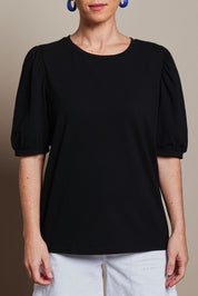 Model Katie wearing size 10 of the Cotton Jersey Puff Sleeve Top in colour Black (Black), from the front, cropped image