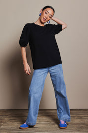 Model Katie wearing size 10 of the Cotton Jersey Puff Sleeve Top in colour Black (Black), from the front, showing the whole outfit