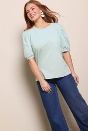 Model Georgiel wearing size 10 of the Cotton Jersey Puff Sleeve Top – Lightsage in colour Lightsage, from an angle