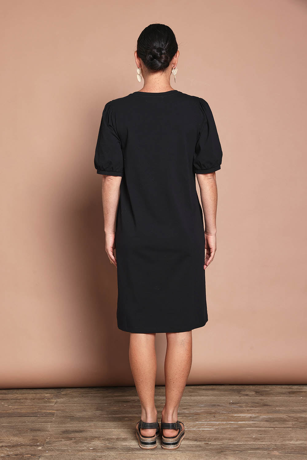 Model Katie wearing size 10 of the Cotton Jersey Puff Sleeve Dress in colour Black (Black), from the back