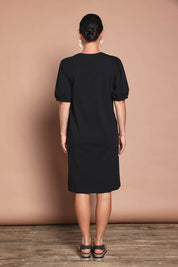 Model Katie wearing size 10 of the Cotton Jersey Puff Sleeve Dress in colour Black (Black), from the back