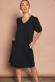 Model Katie wearing size 10 of the Cotton Jersey Puff Sleeve Dress in colour Black (Black), from the front, showing the whole outfit