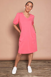 Model Katie wearing size 10 of the Cotton Jersey Puff Sleeve Dress in colour Coralpink (Pink), from the front, showing the whole outfit