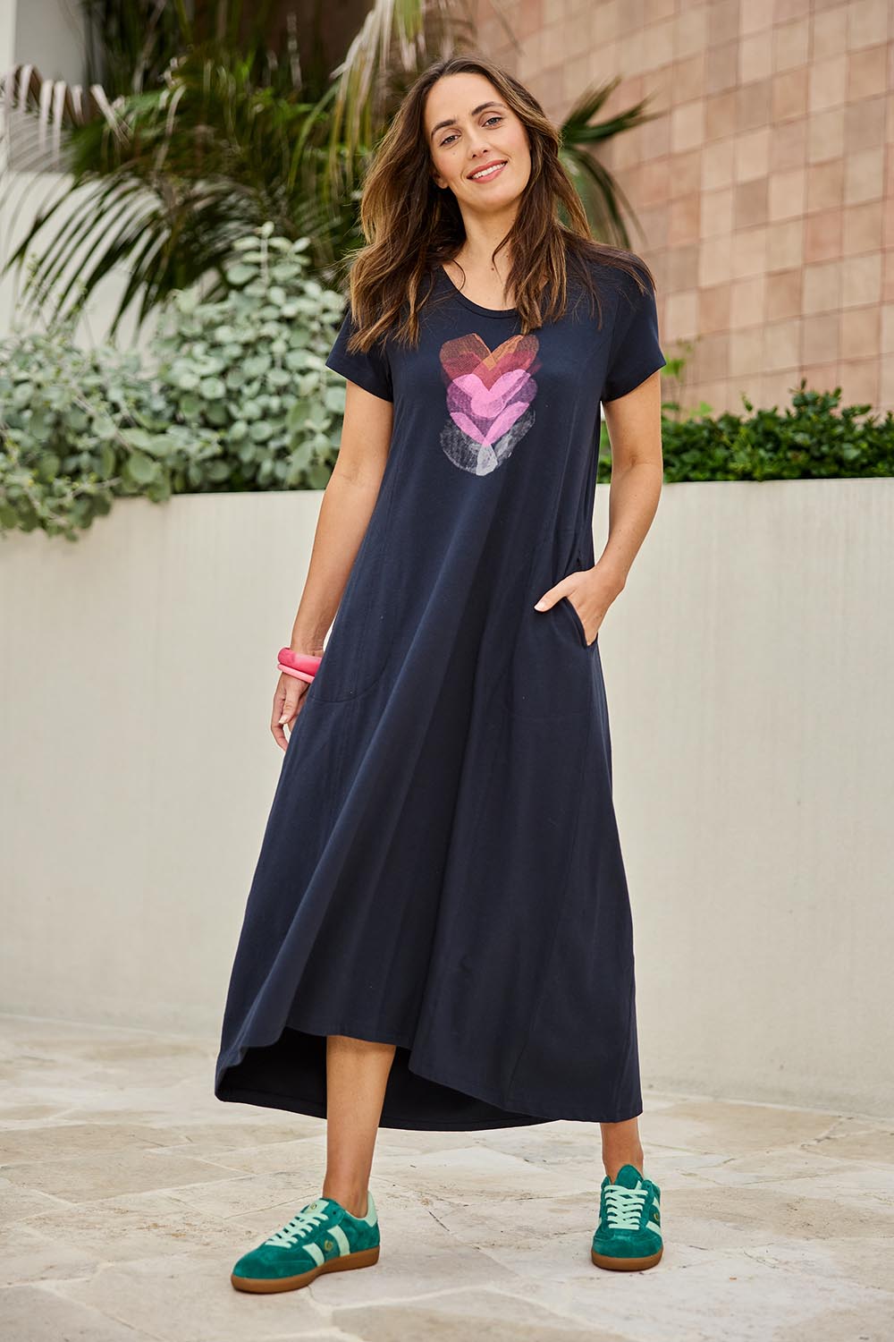 Model Tegand wearing size 10 of the Heart Logo Dress – Inkpink in colour Inkpink, from the front