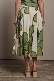 Model Madeline wearing size 10 of the Cotton Flower Skirt in colour Boldflower (Green), from the back