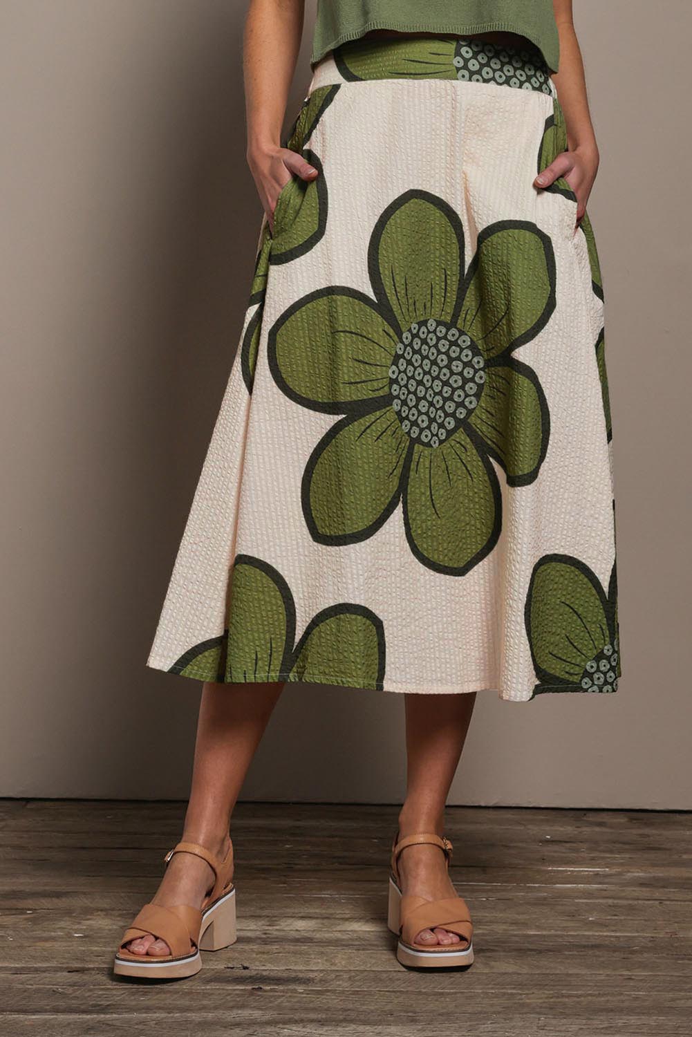 Model Madeline wearing size 10 of the Cotton Flower Skirt in colour Boldflower (Green), from the front, cropped image