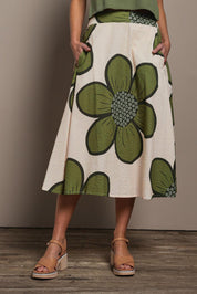Model Madeline wearing size 10 of the Cotton Flower Skirt in colour Boldflower (Green), from the front, cropped image