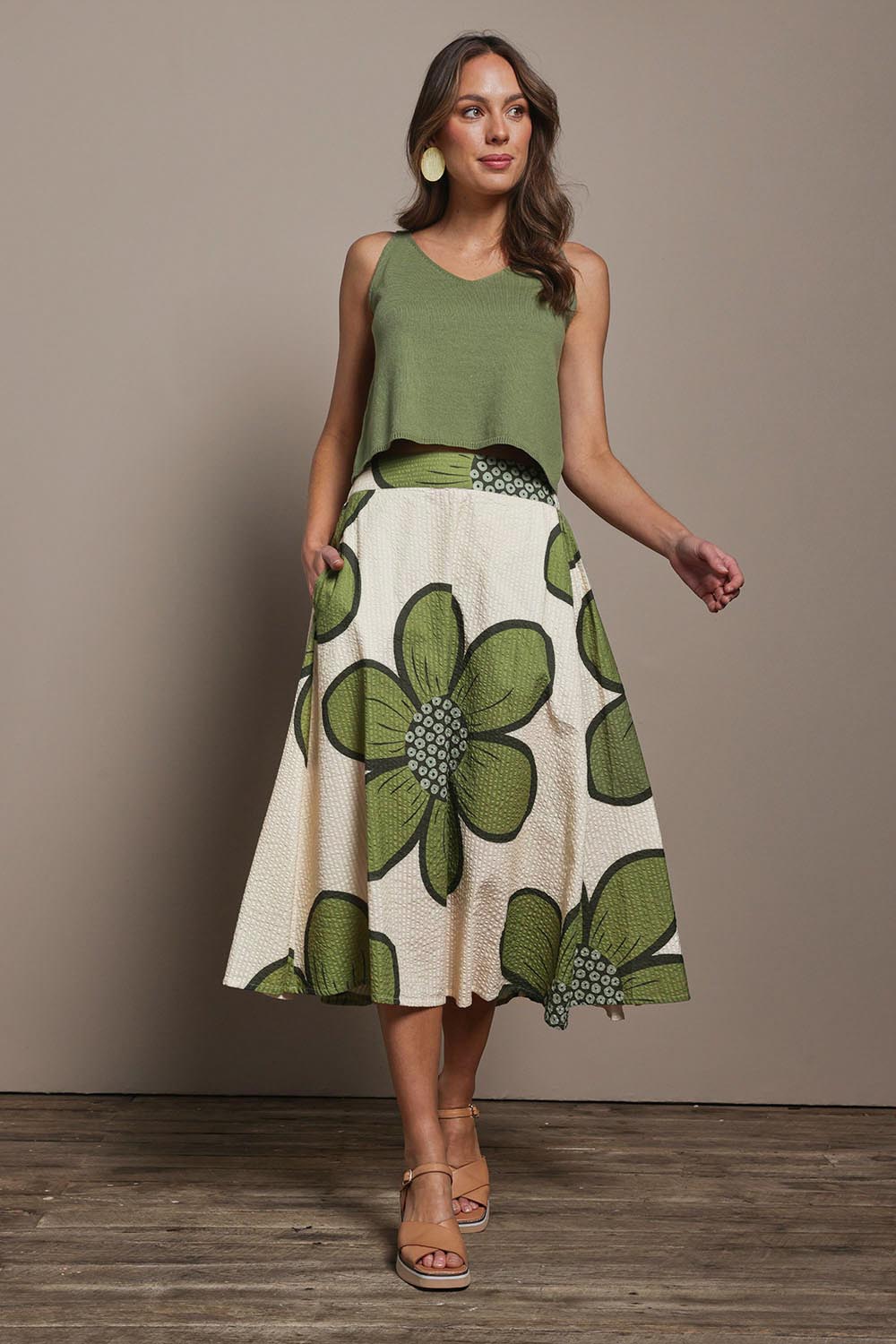 Model Madeline wearing size 10 of the Cotton Flower Skirt in colour Boldflower (Green), from the front, showing the whole outfit