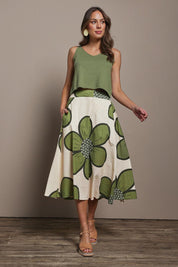 Model Madeline wearing size 10 of the Cotton Flower Skirt in colour Boldflower (Green), from the front, showing the whole outfit