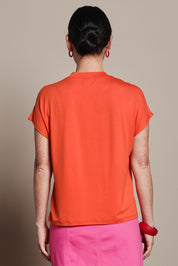 Model Katie wearing size 10 of the Cap Sleeve Tee in colour Tangerine, from the back
