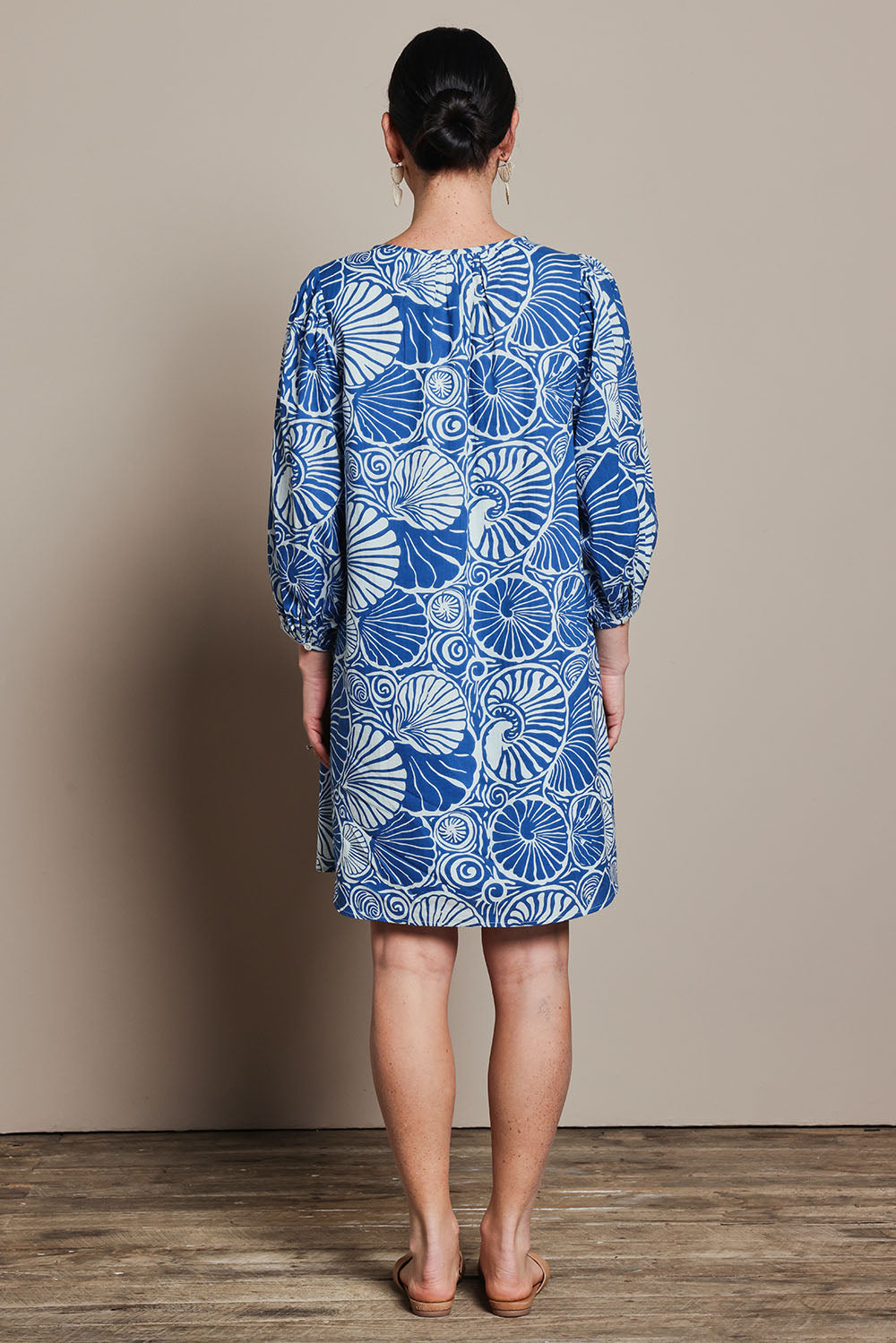 Model Katie wearing size 10 of the Cotton Sundress in colour Shell (Blue), from the back