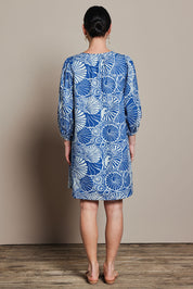 Model Katie wearing size 10 of the Cotton Sundress in colour Shell (Blue), from the back