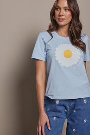Model Madeline wearing size 10 of the Cotton Daisy Tee in colour Blue (Blue), from the front, cropped image