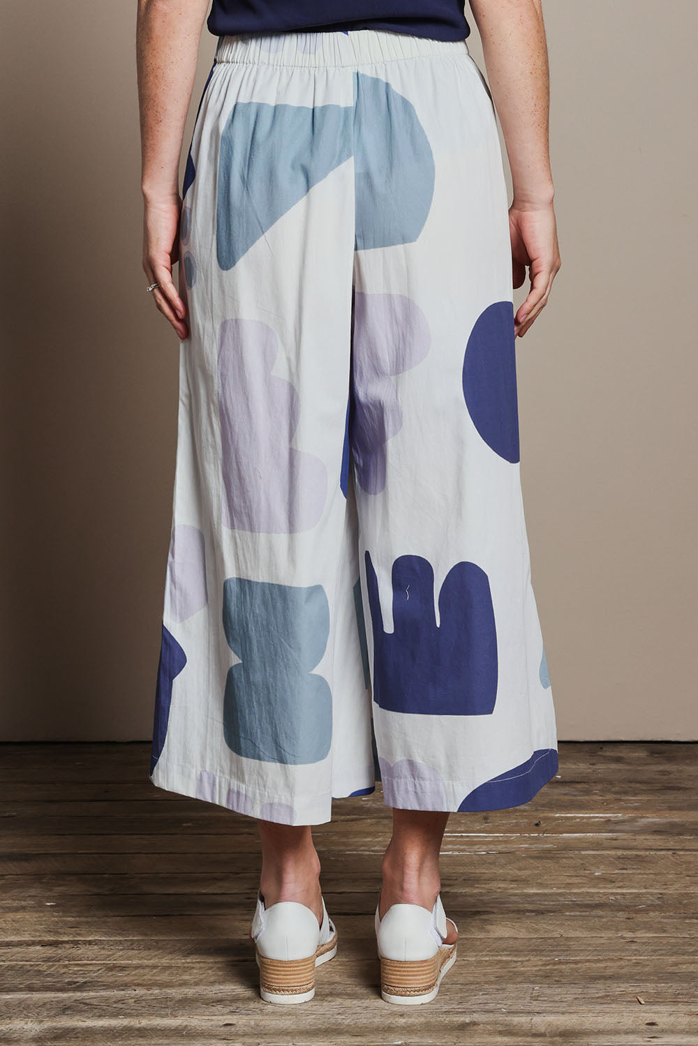 Model Katie wearing size 10 of the Cotton Pull On Pant in colour Abstract (Blue), from the back