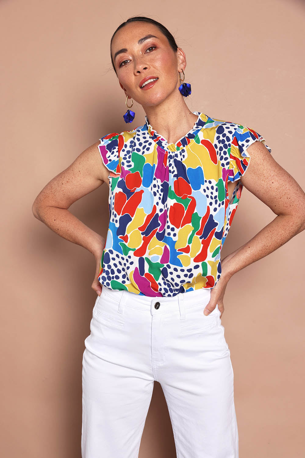 Model Katie wearing size 10 of the Frill Flutter Top in colour Jazzpop, from the front, cropped image