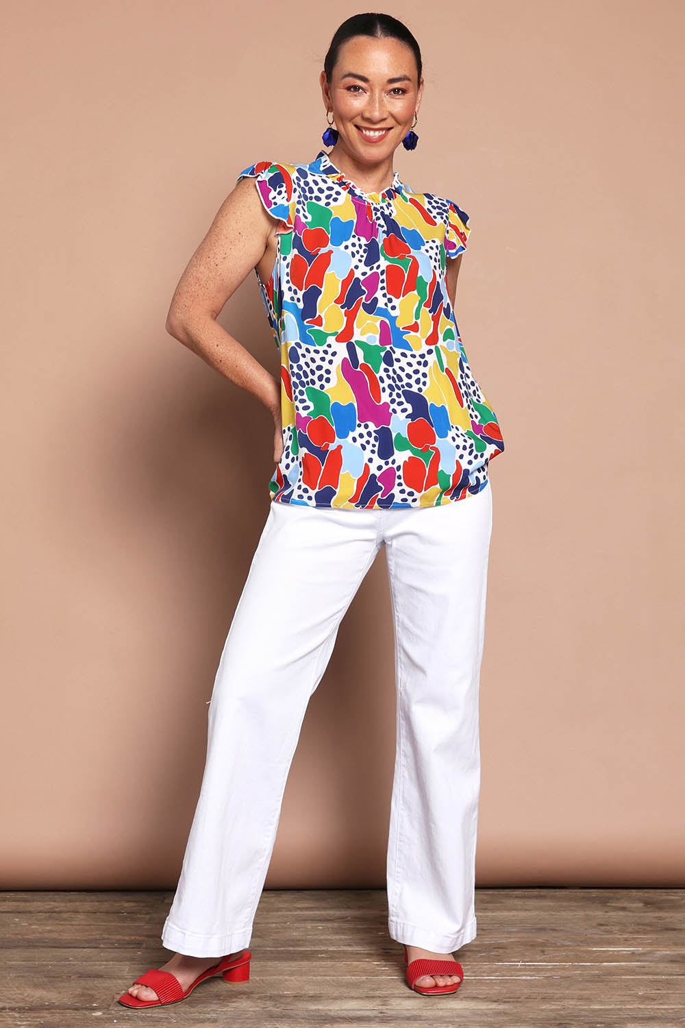 Model Katie wearing size 10 of the Frill Flutter Top in colour Jazzpop, from the front, showing the whole outfit