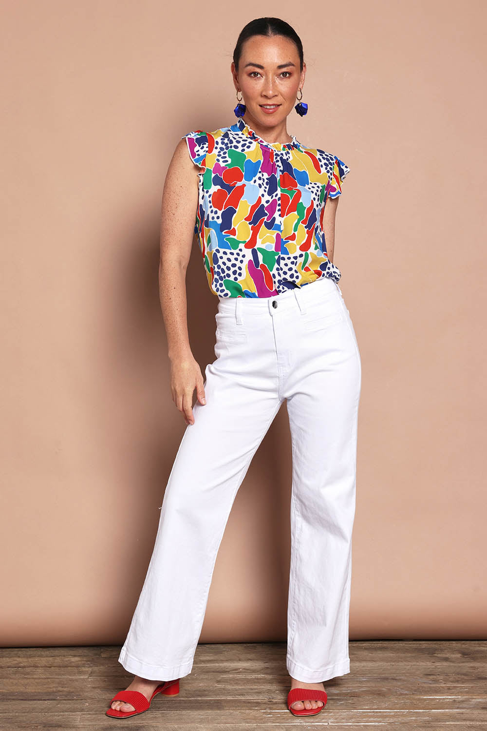 Model Katie wearing size 10 of the Frill Flutter Top in colour Jazzpop, from the front, showing the whole outfit