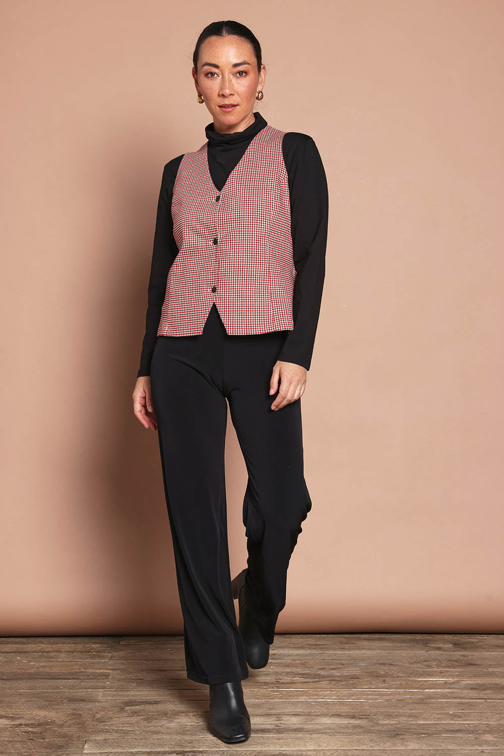 Model Katie wearing size 10 of the Stretch Check Vest in colour Redcheck (Red), from the front, showing the whole outfit