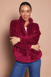 Model Katies wearing size 10 of the Fluffy Jacket - Cerise in colour Cerise, from an angle