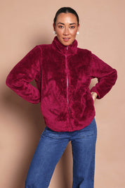 Model Katies wearing size 10 of the Fluffy Jacket - Cerise in colour Cerise, from an angle