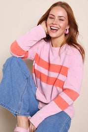 Model Georgiel wearing size 10 of the Contrast Stripe Jumper – Pink in colour Pink, in a cropped view