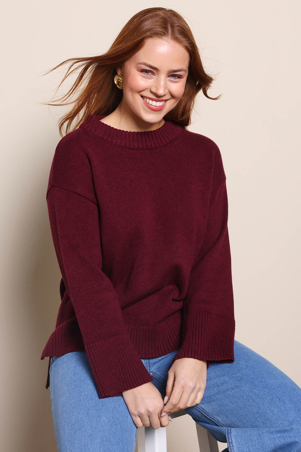 Model Georgiel wearing size 10 of the Cotton Wool Cashmere Jumper – Burgundy in colour Burgundy, in a cropped view