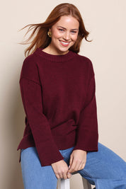 Model Georgiel wearing size 10 of the Cotton Wool Cashmere Jumper – Burgundy in colour Burgundy, in a cropped view