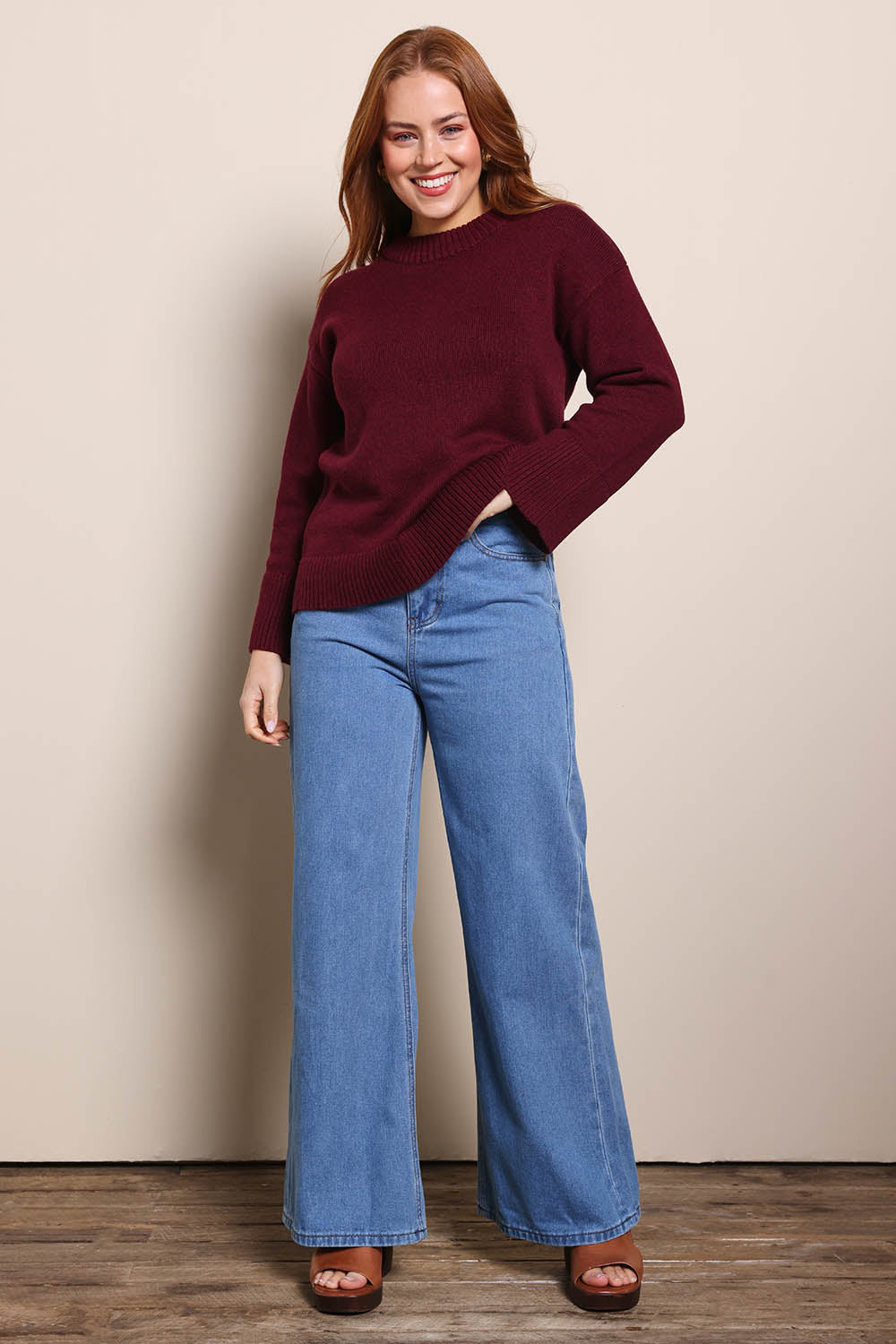 Model Georgiel wearing size 10 of the Cotton Wool Cashmere Jumper – Burgundy in colour Burgundy, from the front