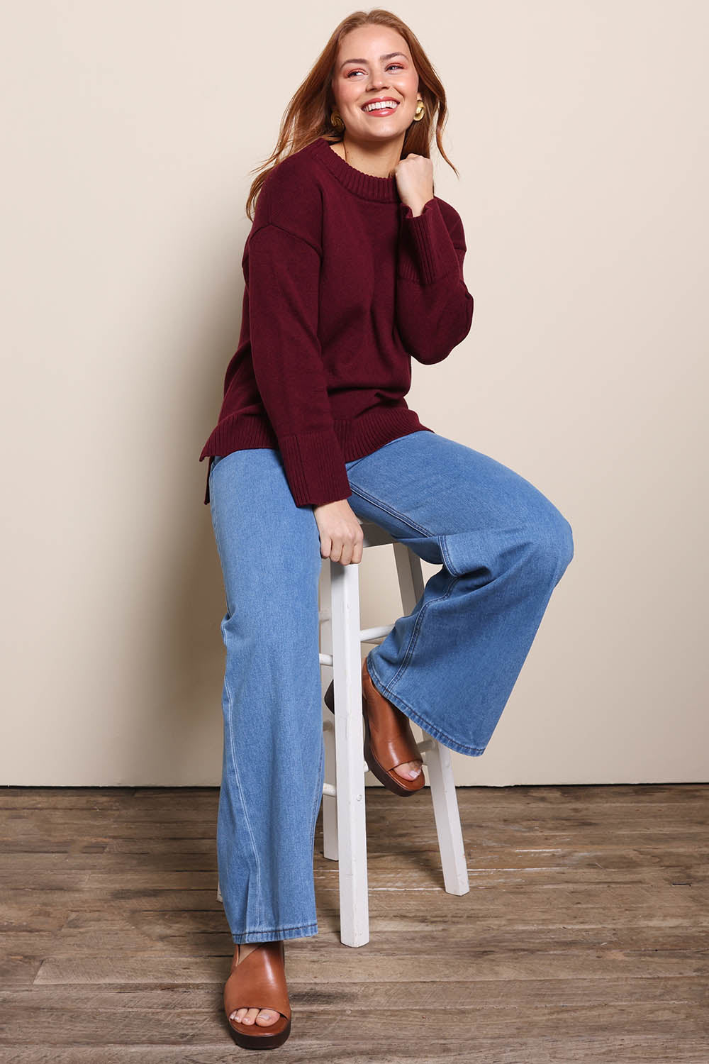 Model Georgiel wearing size 10 of the Cotton Wool Cashmere Jumper – Burgundy in colour Burgundy, from the front