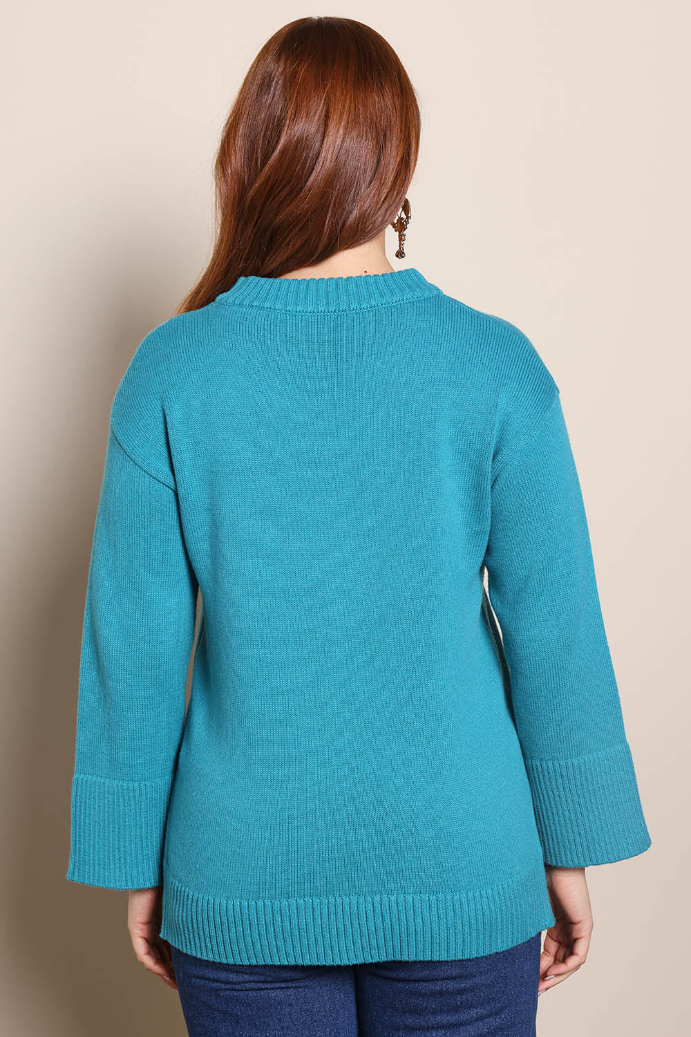 Model Georgiel wearing size 10 of the Cotton Wool Cashmere Jumper – Teal in colour Teal, from the back