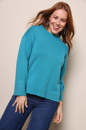 Model Georgiel wearing size 10 of the Cotton Wool Cashmere Jumper – Teal in colour Teal, in a cropped view